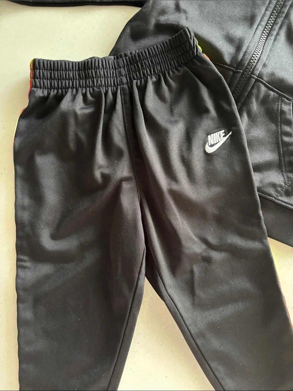 Nike Black Kids Track Set with Red and Yellow Stripe
